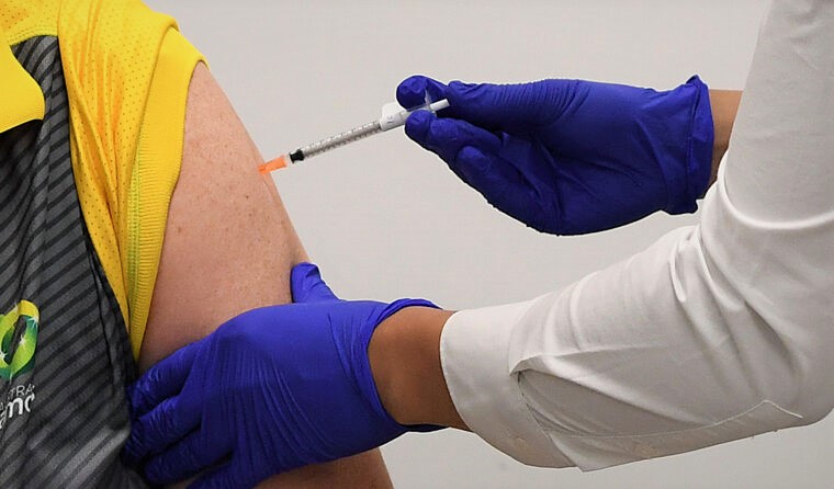 Close-up of vaccine needle in arm
