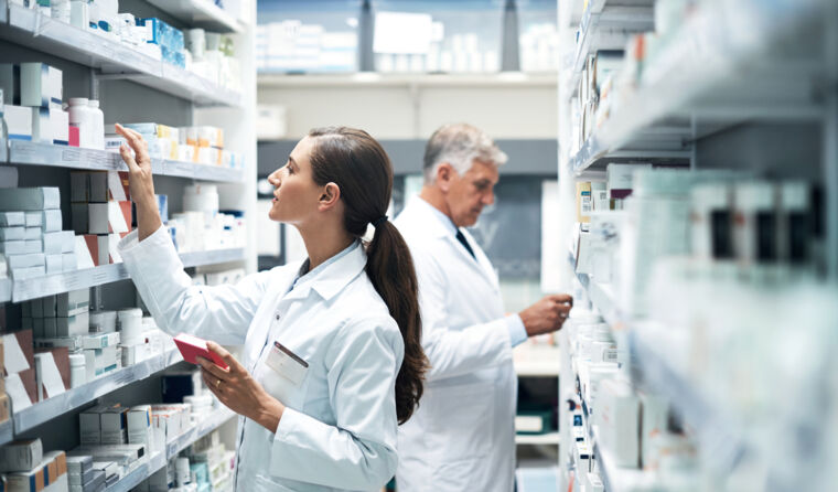 Two pharmacists working at a pharmacy.