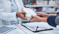 Pharmacist handing over prescription