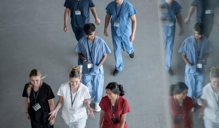 Group of medical practitioners walking and talking