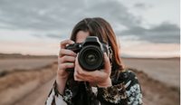 A woman holding a camera. 