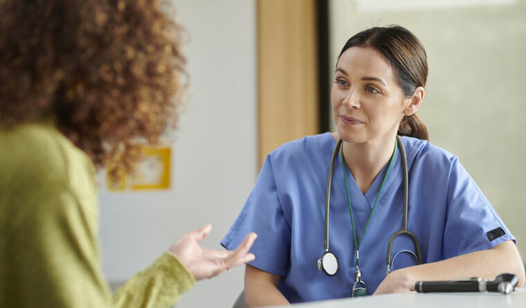 Female GP speaking to a patient. 
