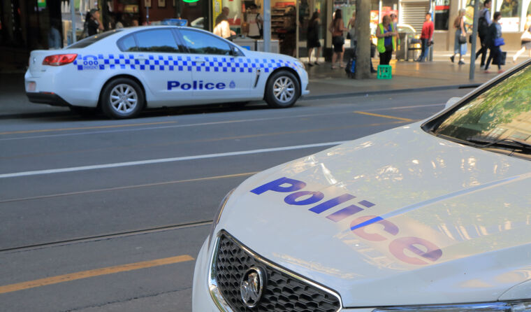 Two police cars sitting on the street.
