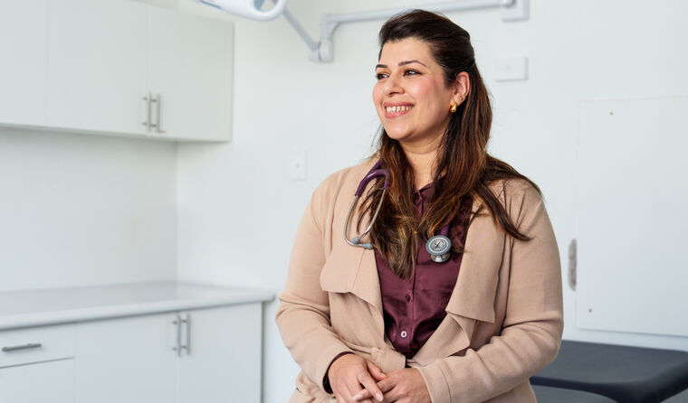 A doctor sitting in her consult room.