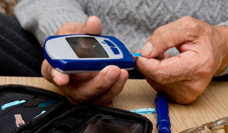 Person with diabetes measuring blood sugar levels.