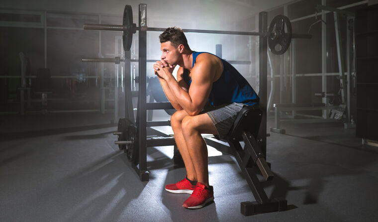 Man at the gym looking sad.