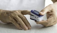 Older woman using a pulse oximeter