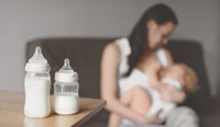 Mother pumping breast milk for storage.