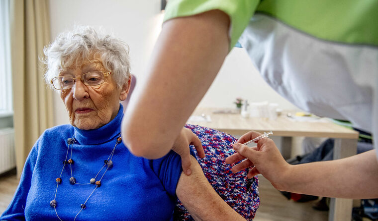 Elderly woman receiving COVID-1booster vaccination