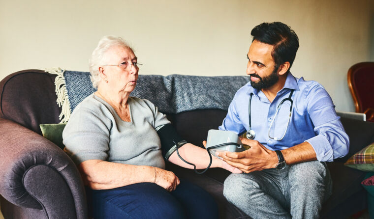 GP sitting on couch with a patient.
