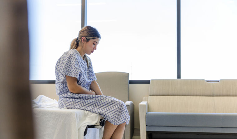 A woman in a hospital bed.