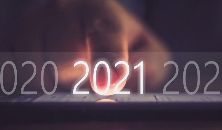 Finger pressing '2021' on keyboard