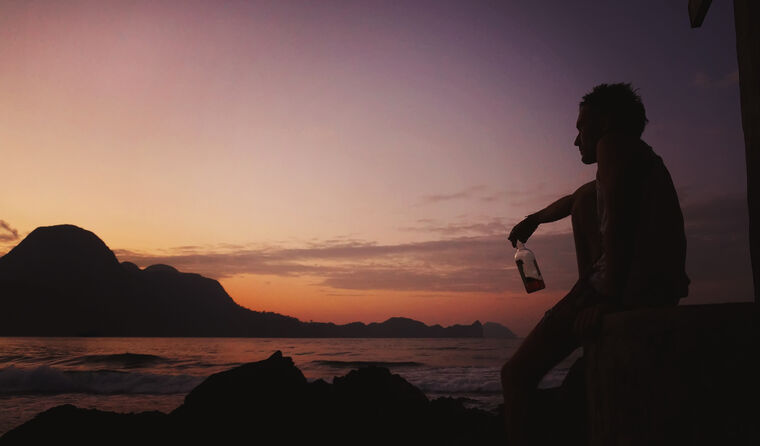 Man at sunset on remote beach