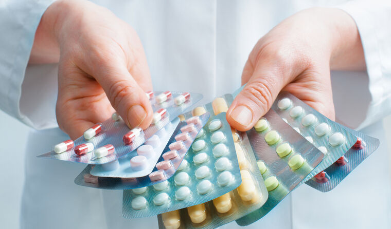 Pharmacist holding medications