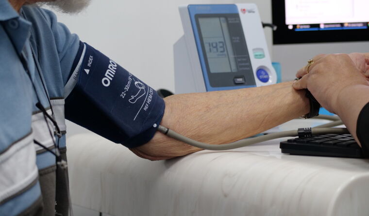 Older patient receiving blood pressure test.
