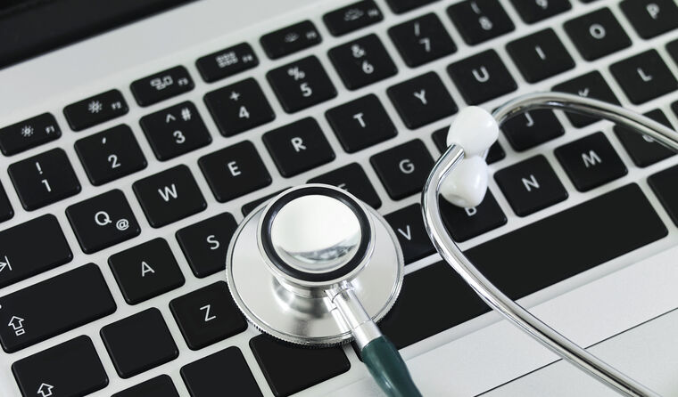 Laptop with stethoscope on the keyboard.