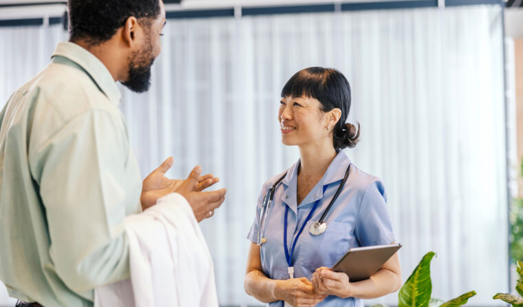 Two medical professionals talking to each other