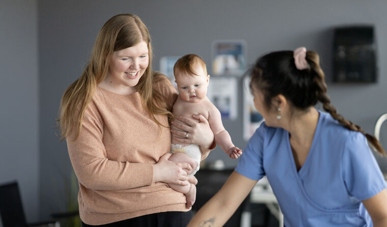 Mum and baby with a GP.
