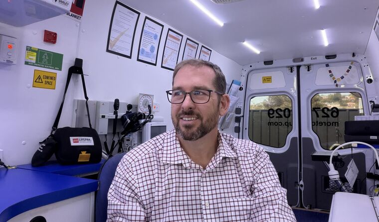 Rob Moreton sitting in his mobile GP clinic.