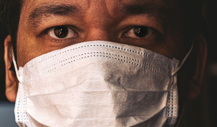 Close up of masked healthcare worker.