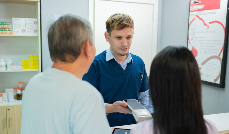Patients paying at GP reception.