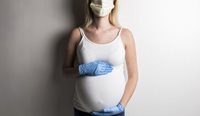Pregnant woman wearing face mask and gloves.