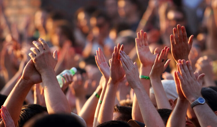 People's hands at a festival.
