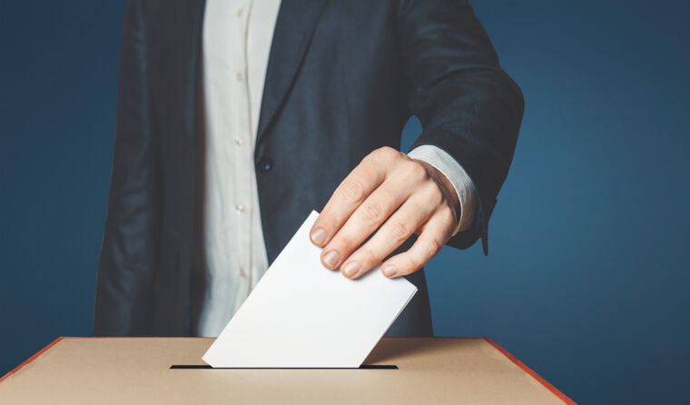 Man placing vote in ballot box