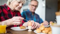 Couple eating boiled egg.