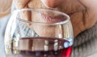 Older person drinking wine