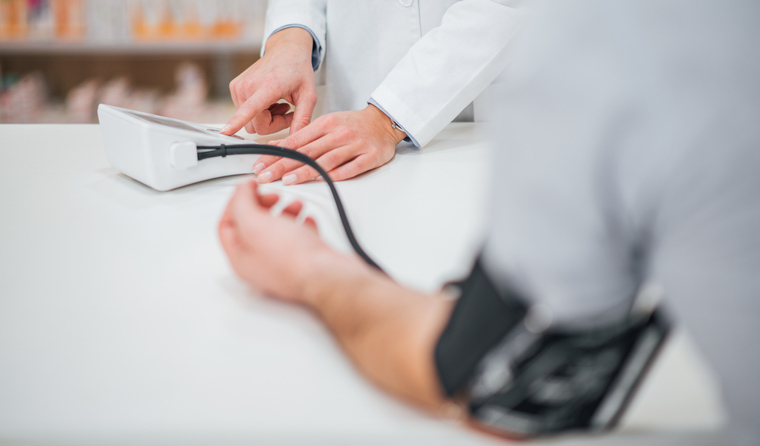 Man getting blood pressure checked at pharmacist.