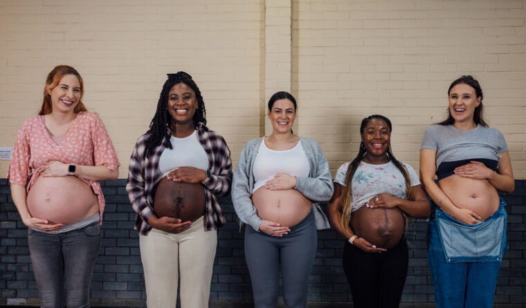 Pregnant women standing in a row.