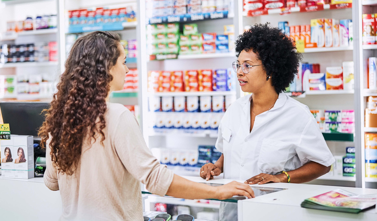 Pharmacist speaking to a female customer.