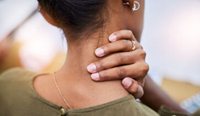Female rubbing neck in pain
