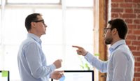 Two men arguing in an office.