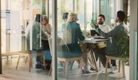 People sit around a table at a meeting.