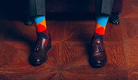 man wearing odd socks