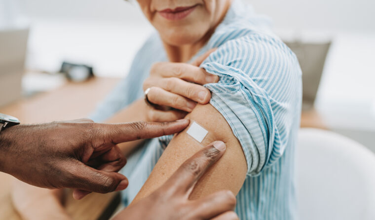Doctor giving a vaccine in patient's arm. 