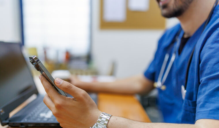 GP on his phone and using computer.