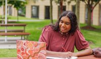 Female Aboriginal student at laptop on campus