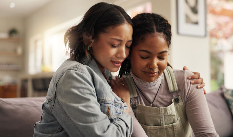 Two women hugging.