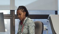 Female GP looking at computer for referral advice
