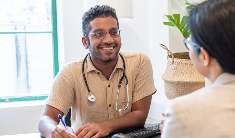 Young doctor smiling with patient