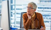 Female GP at the computer