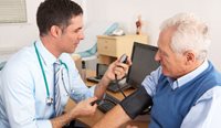 GP checking patient blood pressure