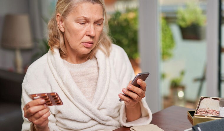 Woman looking at medication details on phone