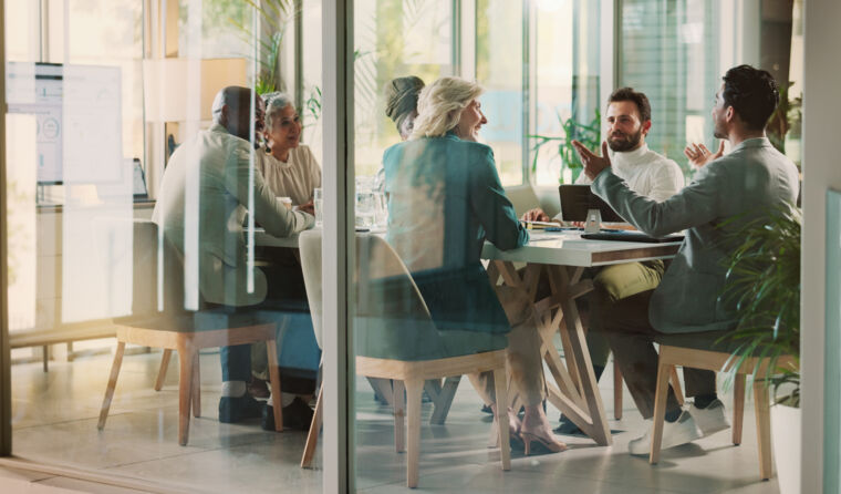 People sit around a table at a meeting.