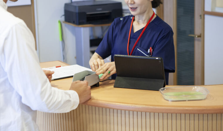 Someone paying at a doctor's clinic