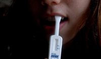 Person using oral fluid HIV self-test.