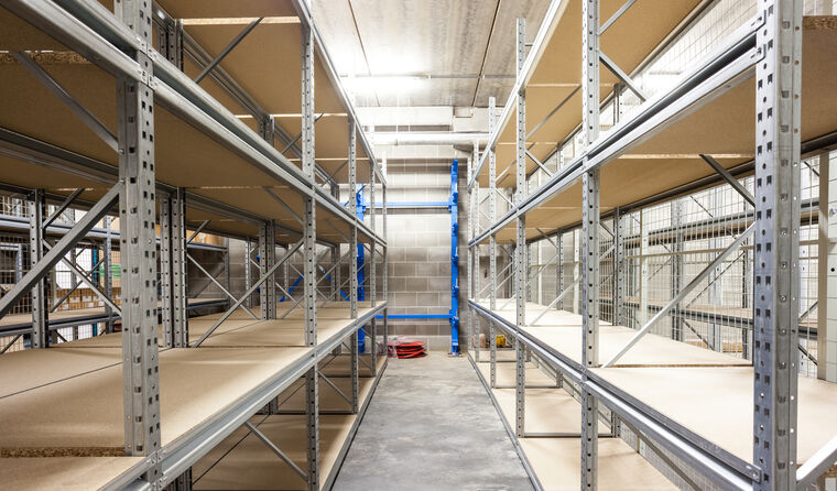 Empty storage racks in a building with security.